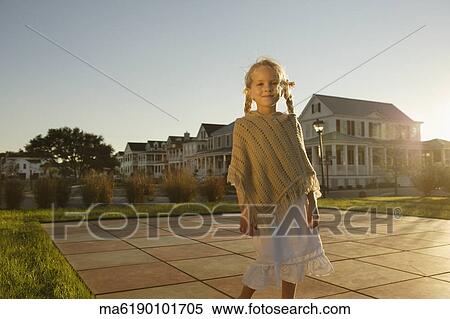 Young girl standing in backyard View Large Photo Image Stock Photography - Young girl standing in backyard. Fotosearch