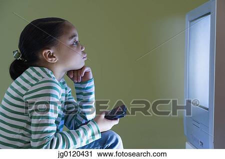 Young girl watching television View Large Photo Image Stock Image - Young girl watching television. Fotosearch