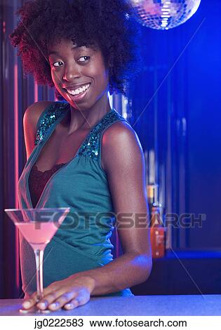 Young woman at a dance club View Large Photo Image Stock Image - Young woman at a dance club. Fotosearch