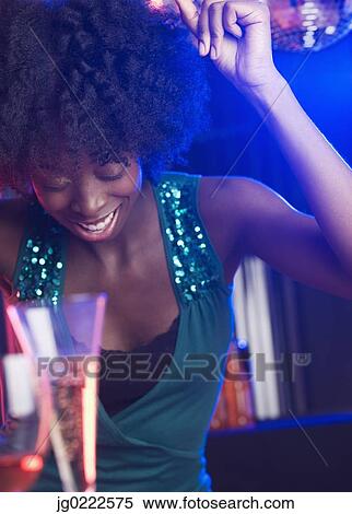 Young woman at a dance club View Large Photo Image Stock Photography - Young woman at a dance club. Fotosearch