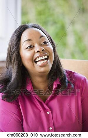 Stock Image - Young woman laughing. Fotosearch