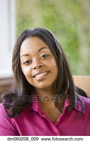Young woman smiling View Large Photo Image Stock Photo - Young woman smiling. Fotosearch