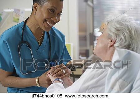 African female nurse holding patient's hand, Bethesda, Maryland, United States View Large Photo Image Stock Photography - African female nurse holding patient's hand, Bethesda, Maryland, United States. Fotosearch