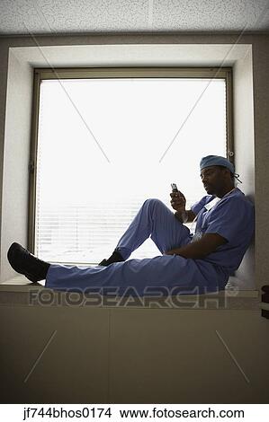 African male surgeon sitting in window alcove View Large Photo Image Picture - African male surgeon sitting in window alcove. Fotosearch