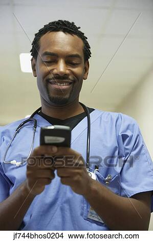African male surgeon using electronic organizer View Large Photo Image Picture - African male surgeon using electronic organizer. Fotosearch