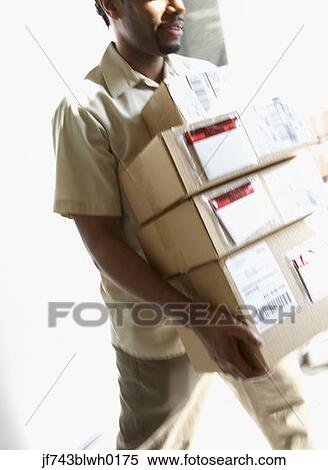 Stock Photography - African man carrying packages. Fotosearch