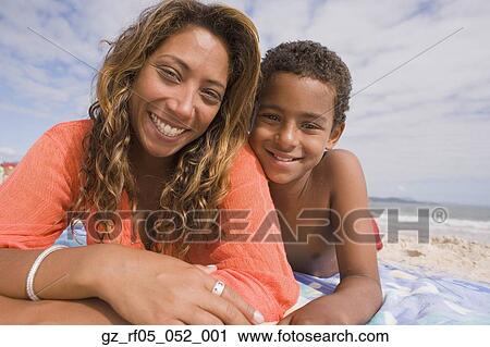 African mother and son lying on the beach, Florianopolis, Brazil View Large Photo Image Stock Image - African mother and son lying on the beach, Florianopolis, Brazil. Fotosearch