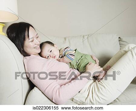 Asian mother and baby on the sofa View Large Photo Image Stock Photography - Asian mother and baby on the sofa. Fotosearch