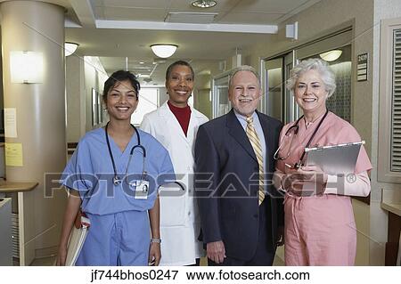 Stock Photo - Businessman with hospital staff in hospital, Bethesda, Maryland, United States. Fotosearch