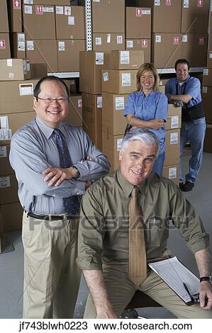 Businessmen with warehouse workers in warehouse View Large Photo Image Stock Image - Businessmen with warehouse workers in warehouse. Fotosearch