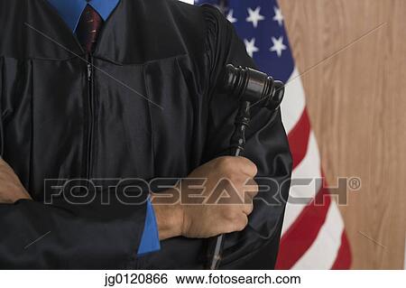 Close of African male judge holding gavel View Large Photo Image Stock Photograph - Close of African male judge holding gavel. Fotosearch