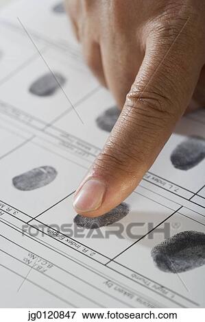 Stock Photo - Close up of African male hand and fingerprint card. Fotosearch