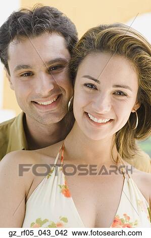 Close up of couple hugging View Large Photo Image Stock Image - Close up of couple hugging. Fotosearch