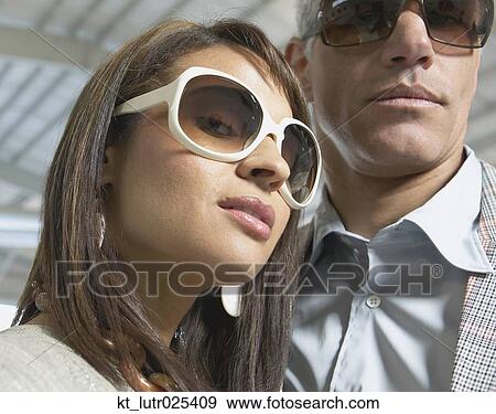 Close up of couple in airplane hanger, Nobato, California, United States View Large Photo Image Stock Photo - Close up of couple in airplane hanger, Nobato, California, United States. Fotosearch