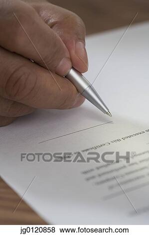 Close up of man signing document View Large Photo Image Stock Photo - Close up of man signing document. Fotosearch