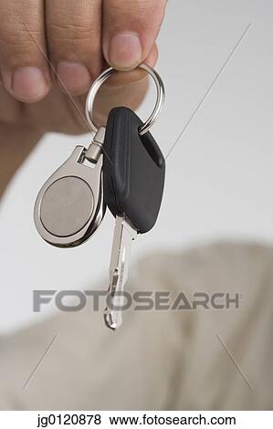 Close up of man's hand holding car key View Large Photo Image Stock Photo - Close up of man's hand holding car key. Fotosearch