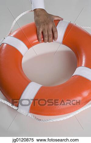 Close up of man's hand holding life preserver View Large Photo Image Stock Photography - Close up of man's hand holding life preserver. Fotosearch