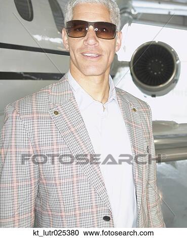 Close up of middle-aged man standing in front of airplane, Nobato, California, United States View Large Photo Image Stock Image - Close up of middle-aged man standing in front of airplane, Nobato, California, United States. Fotosearch