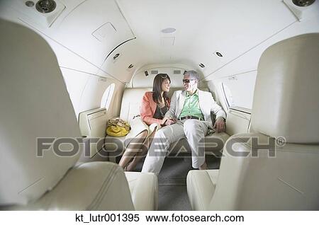 Stock Photography - Couple sitting in private jet, Nobato, California, United States. Fotosearch