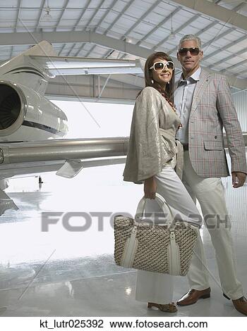 Couple standing in airplane hanger, Nobato, California, United States View Large Photo Image Stock Image - Couple standing in airplane hanger, Nobato, California, United States. Fotosearch