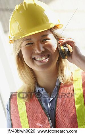 Female construction worker on cell phone View Large Photo Image Stock Photograph - Female construction worker on cell phone. Fotosearch