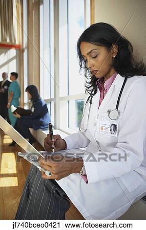 Female Indian doctor marking on a chart View Large Photo Image Stock Image - Female Indian doctor marking on a chart. Fotosearch
