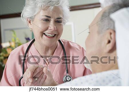 Female nurse holding patient's hand View Large Photo Image Stock Image - Female nurse holding patient's hand. Fotosearch