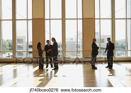 Group of businesspeople talking in sunlit room, North Bethesda, Maryland, United States View Large Photo Image Stock Photograph - Group of businesspeople talking in sunlit room, North Bethesda, Maryland, United States. Fotosearch