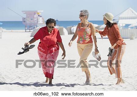Stock Image - Group of middle-aged women at the beach, Miami, Florida, United States. Fotosearch