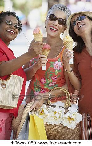 Group of middle-aged women eating ice cream cones, Miami, Florida, United States View Large Photo Image Stock Image - Group of middle-aged women eating ice cream cones, Miami, Florida, United States. Fotosearch