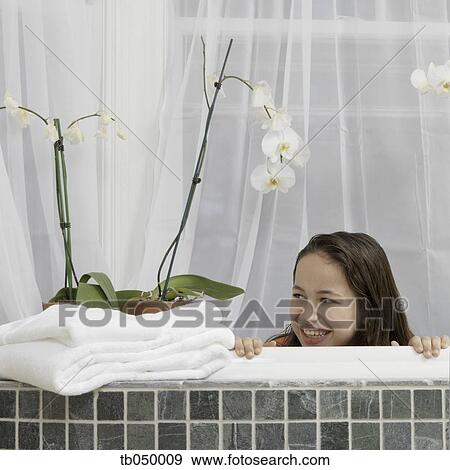 Hispanic girl smiling in bathtub View Large Photo Image Stock Photo - Hispanic girl smiling in bathtub. Fotosearch