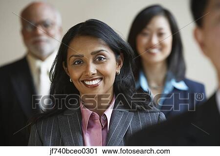 Indian businesswoman with co-workers in the background View Large Photo Image Stock Image - Indian businesswoman with co-workers in the background. Fotosearch