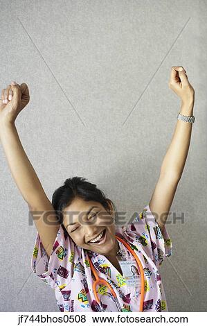 Stock Photo - Indian female nurse yawning and stretching. Fotosearch