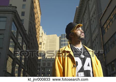 Low angle view of young African man standing in urban area, Oakland, California, United States View Large Photo Image Stock Image - Low angle view of young African man standing in urban area, Oakland, California, United States. Fotosearch