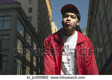 Low angle view of young African man standing in urban area, Oakland, California, United States View Large Photo Image Stock Image - Low angle view of young African man standing in urban area, Oakland, California, United States. Fotosearch