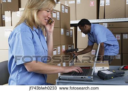 Male and female warehouse workers in warehouse View Large Photo Image Stock Image - Male and female warehouse workers in warehouse. Fotosearch