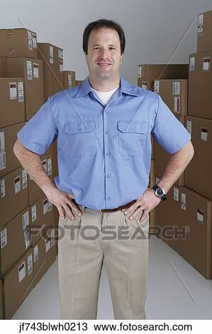 Stock Image - Male warehouse worker in warehouse. Fotosearch