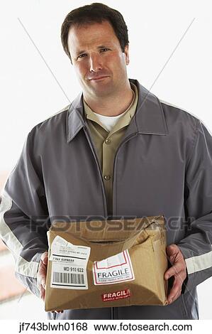 Stock Photo - Man holding crushed package marked Fragile. Fotosearch