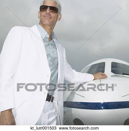 Man standing with his hand on the nose of a small jet, Nobato, California, United States View Large Photo Image Stock Image - Man standing with his hand on the nose of a small jet, Nobato, California, United States. Fotosearch