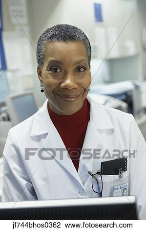 Stock Image - Middle-aged African female doctor smiling. Fotosearch
