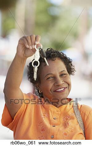 Middle-aged African woman holding up her car keys, Miami, Florida, United States View Large Photo Image Stock Image - Middle-aged African woman holding up her car keys, Miami, Florida, United States. Fotosearch