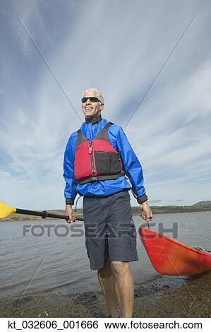 Middle-aged man pulling kayak out of the water, California, United States View Large Photo Image Stock Photograph - Middle-aged man pulling kayak out of the water, California, United States. Fotosearch