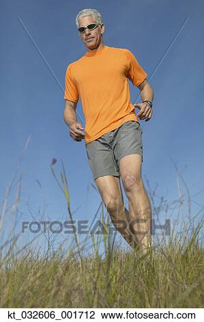 Middle-aged man walking through grass, California, United States View Large Photo Image Stock Image - Middle-aged man walking through grass, California, United States. Fotosearch