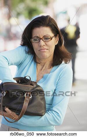 Middle-aged woman digging in her purse, Miami, Florida, United States View Large Photo Image Stock Image - Middle-aged woman digging in her purse, Miami, Florida, United States. Fotosearch