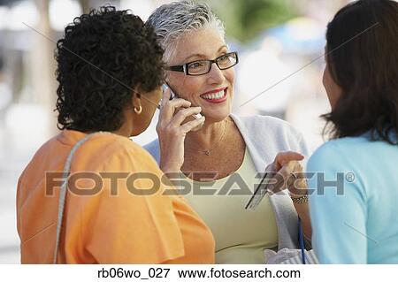 Middle-aged woman on cell phone with credit card, Miami, Florida, United States View Large Photo Image Stock Photo - Middle-aged woman on cell phone with credit card, Miami, Florida, United States. Fotosearch