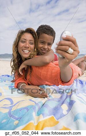 Mother and son taking self portrait on the beach, Florianopolis, Brazil View Large Photo Image Picture - Mother and son taking self portrait on the beach, Florianopolis, Brazil. Fotosearch