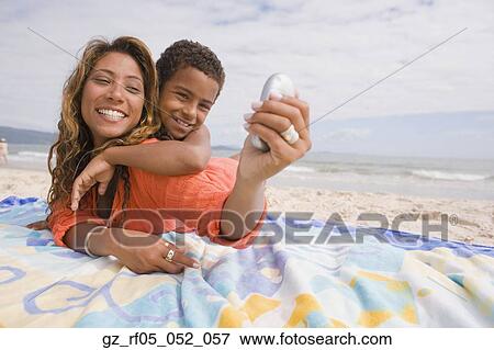 Mother and son taking self portrait on the beach, Florianopolis, Brazil View Large Photo Image Stock Photo - Mother and son taking self portrait on the beach, Florianopolis, Brazil. Fotosearch