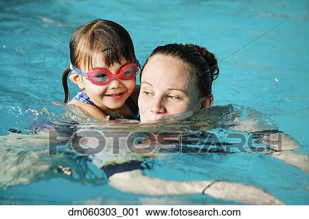 Mother and young daughter swimming View Large Photo Image Stock Image - Mother and young daughter swimming. Fotosearch