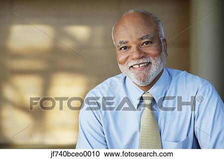 Senior African businessman smiling View Large Photo Image Stock Image - Senior African businessman smiling. Fotosearch
