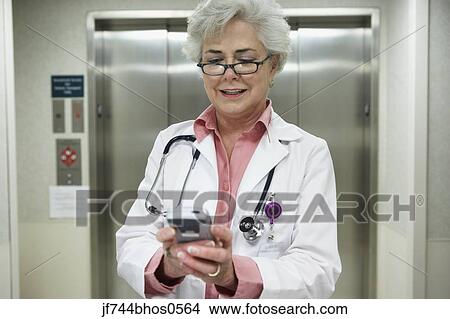Senior female doctor using electronic organizer, Bethesda, Maryland, United States View Large Photo Image Picture - Senior female doctor using electronic organizer, Bethesda, Maryland, United States. Fotosearch